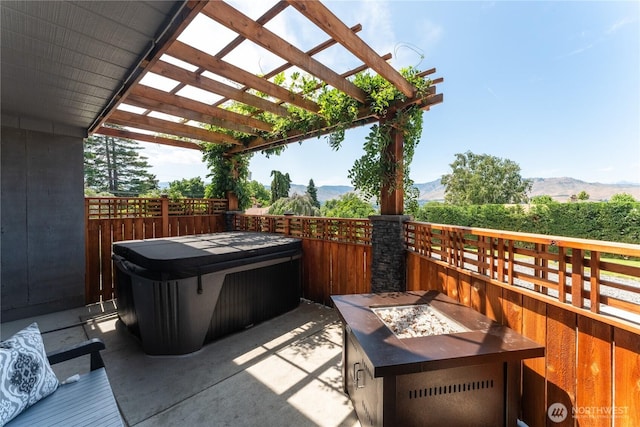 2540 N Astor Ave, East Wenatchee, WA 98801 - view of patio featuring a mountain view, a hot tub, a pergola, and a fire pit