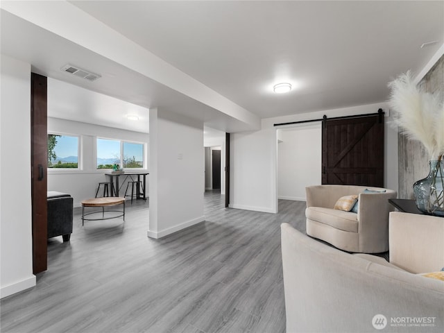 2540 N Astor Ave, East Wenatchee, WA 98801 - living room featuring a barn door and light wood-style flooring