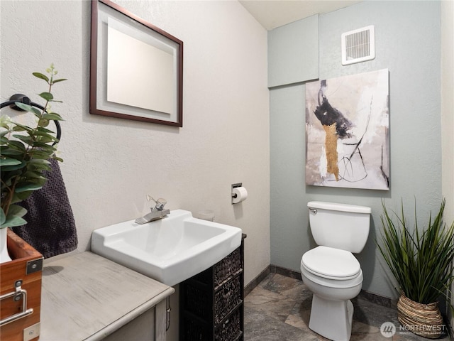 2540 N Astor Ave, East Wenatchee, WA 98801 - bathroom featuring toilet and stone finish flooring