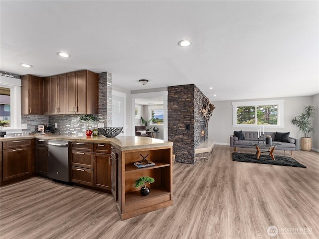 2540 N Astor Ave, East Wenatchee, WA 98801 - kitchen featuring stainless steel dishwasher, open floor plan, a peninsula, light wood-style floors, and light countertops