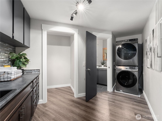 2540 N Astor Ave, East Wenatchee, WA 98801 - laundry room featuring stacked washing machine and dryer and light wood-type flooring
