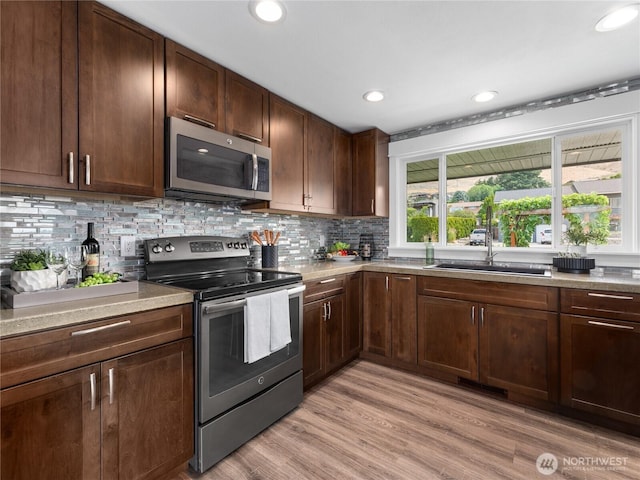 2540 N Astor Ave, East Wenatchee, WA 98801 - kitchen featuring stainless steel appliances, light wood-type flooring, tasteful backsplash, recessed lighting, and light countertops