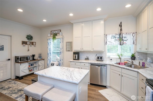 170 E Soundview Dr E, Shelton, WA 98584 - kitchen featuring appliances with stainless steel finishes, backsplash, crown molding, light wood-type flooring, and white cabinetry