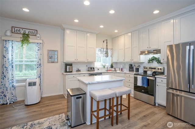 170 E Soundview Dr E, Shelton, WA 98584 - kitchen featuring stainless steel appliances, under cabinet range hood, light wood-type flooring, a kitchen island, and recessed lighting