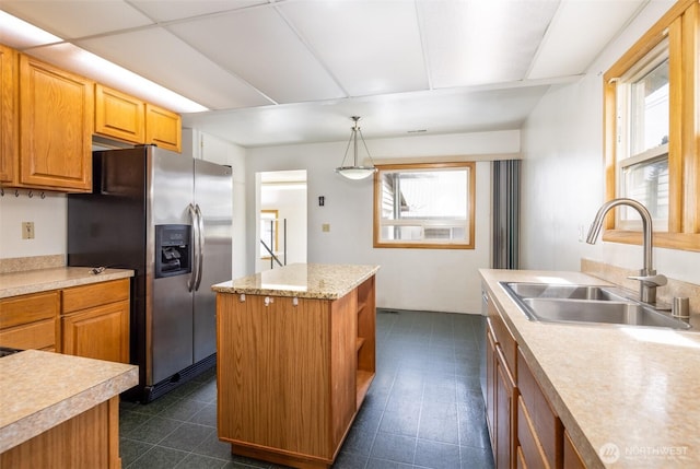 819 1st St, Cle Elum, WA 98922 - kitchen featuring stainless steel fridge with ice dispenser, light countertops, a center island, and hanging light fixtures