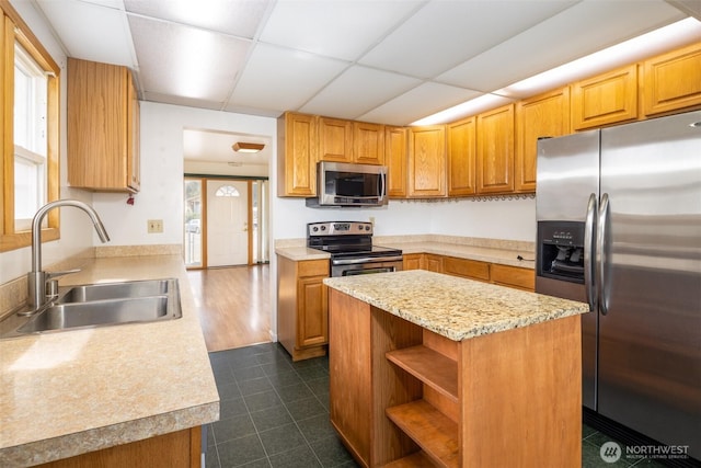 819 1st St, Cle Elum, WA 98922 - kitchen featuring stainless steel appliances, a paneled ceiling, dark tile patterned floors, a center island, and open shelves