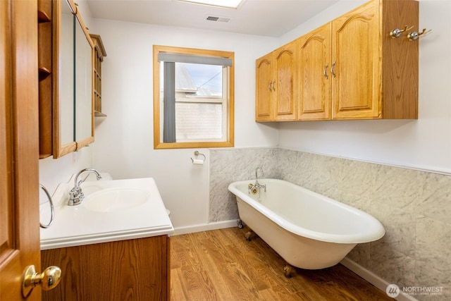 819 1st St, Cle Elum, WA 98922 - full bathroom featuring vanity, a freestanding tub, and wood finished floors