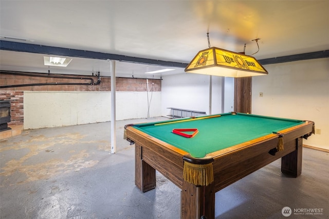 819 1st St, Cle Elum, WA 98922 - playroom featuring unfinished concrete flooring, billiards, and a wood stove