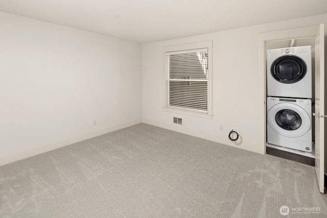 22910 90th Ave W Unit B306, Edmonds, WA 98026 - laundry area featuring stacked washer / dryer and carpet floors
