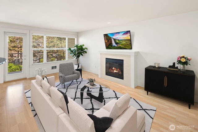 22910 90th Ave W Unit B306, Edmonds, WA 98026 - living area with light wood-style flooring, a glass covered fireplace, and recessed lighting