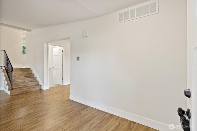 1003 9th St NW, Puyallup, WA 98371 - empty room featuring light wood-style flooring and stairs