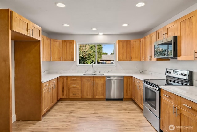 1003 9th St NW, Puyallup, WA 98371 - kitchen with stainless steel appliances, light wood finished floors, recessed lighting, and light stone countertops