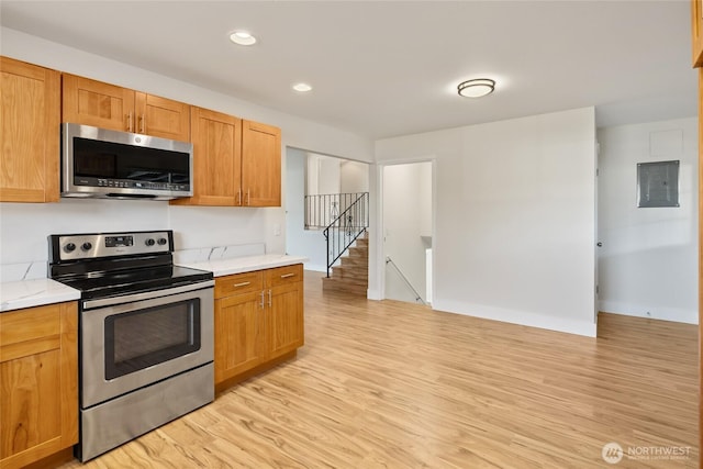 1003 9th St NW, Puyallup, WA 98371 - kitchen with appliances with stainless steel finishes, light wood-style floors, light countertops, and recessed lighting