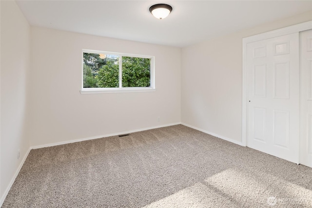 1003 9th St NW, Puyallup, WA 98371 - unfurnished bedroom with carpet floors and baseboards