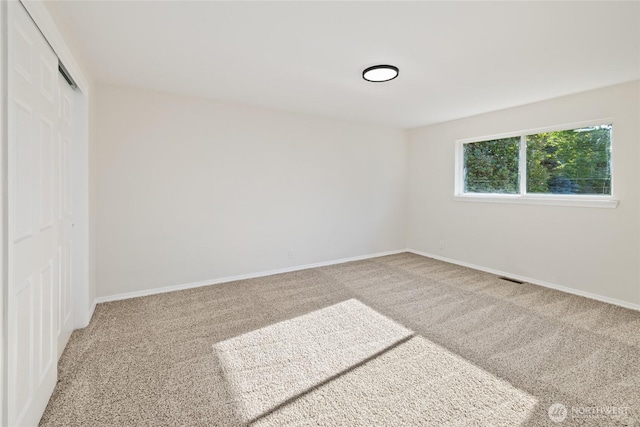 1003 9th St NW, Puyallup, WA 98371 - unfurnished bedroom with carpet floors and a closet
