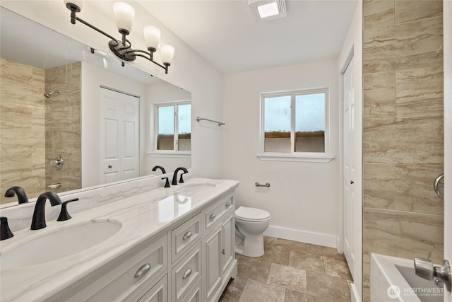 1003 9th St NW, Puyallup, WA 98371 - full bath featuring double vanity, stone finish flooring, and shower / washtub combination