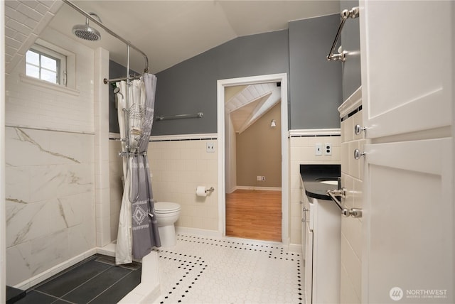 1016 N Madison St, Tacoma, WA 98406 - full bath featuring lofted ceiling, tile walls, vanity, tiled shower, and tile patterned flooring