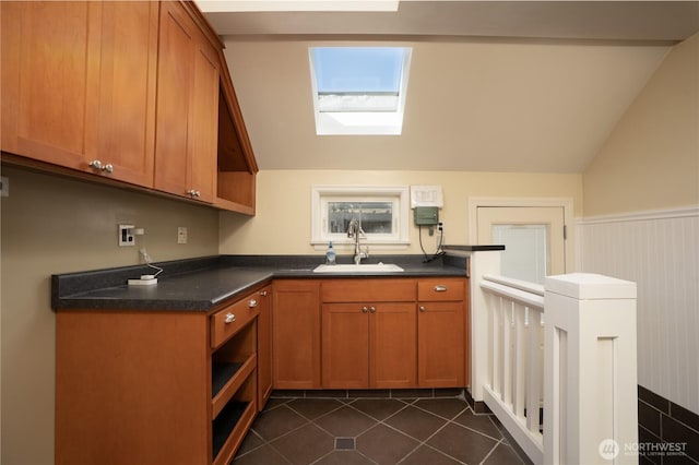 1016 N Madison St, Tacoma, WA 98406 - kitchen featuring a skylight, open shelves, lofted ceiling, brown cabinets, and dark countertops