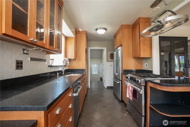 1016 N Madison St, Tacoma, WA 98406 - kitchen featuring appliances with stainless steel finishes, brown cabinetry, backsplash, and dark countertops