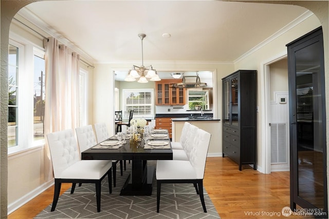 1016 N Madison St, Tacoma, WA 98406 - dining space with a chandelier, crown molding, and light wood-style flooring