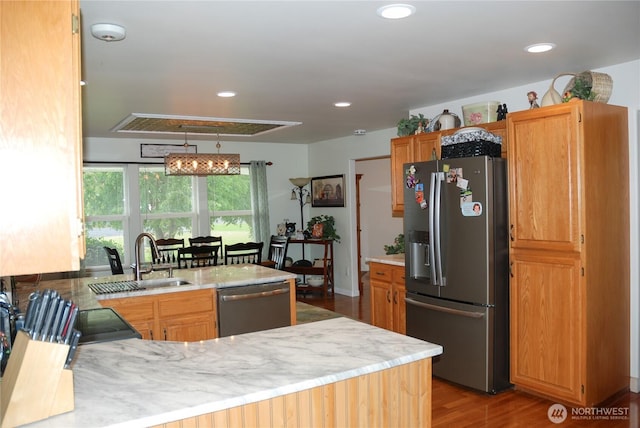 3081 Wild Goose Rd NE, Moses Lake, WA 98837 - kitchen with stainless steel appliances, wood finished floors, recessed lighting, and a peninsula