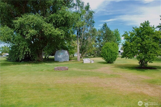 3081 Wild Goose Rd NE, Moses Lake, WA 98837 - view of green lawn with a shed and an outdoor fire pit