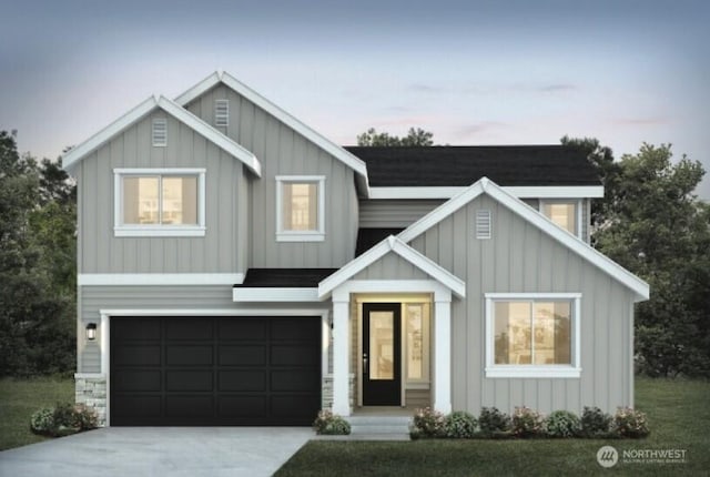 7150 90th Street Ct E, Puyallup, WA 98371 - view of front of home with board and batten siding, driveway, and a garage