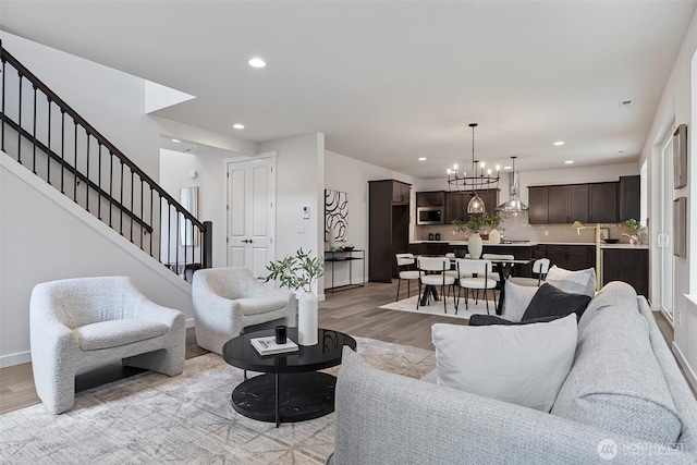 7150 90th Street Ct E, Puyallup, WA 98371 - living room with stairway, light wood-style floors, recessed lighting, a chandelier, and baseboards