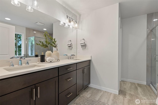 7150 90th Street Ct E, Puyallup, WA 98371 - full bath featuring double vanity, wood finished floors, a shower stall, and baseboards