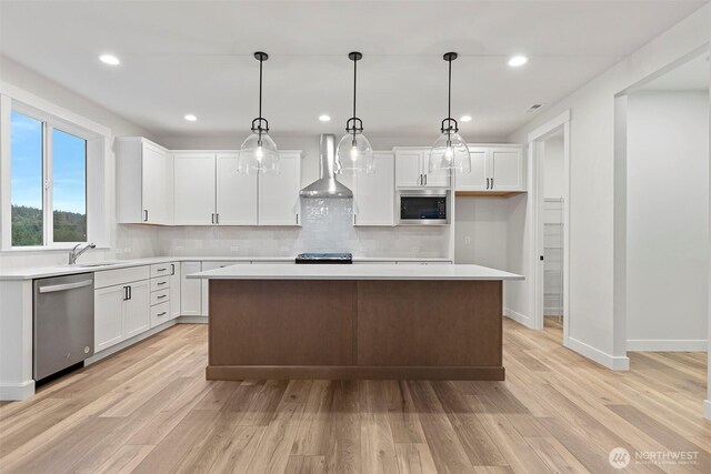 9036 71st Avenue Ct E, Puyallup, WA 98371 - kitchen featuring wall chimney exhaust hood, appliances with stainless steel finishes, light wood-style floors, white cabinets, and recessed lighting