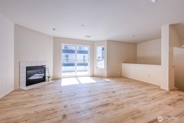 16219 Northup Way Unit C-202, Bellevue, WA 98008 - unfurnished living room featuring wood finished floors and a fireplace