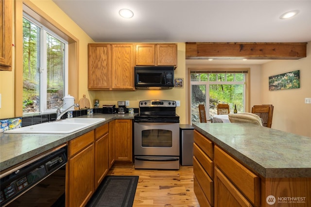 1026 Chinook Way, Center Island, WA 98221 - kitchen featuring black appliances, light wood finished floors, recessed lighting, brown cabinets, and beamed ceiling