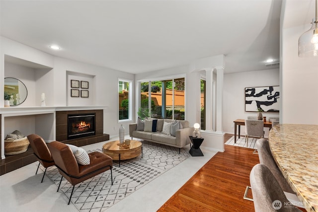 11734 167th Ct NE, Redmond, WA 98052 - living area with recessed lighting, a fireplace, wood finished floors, and ornate columns