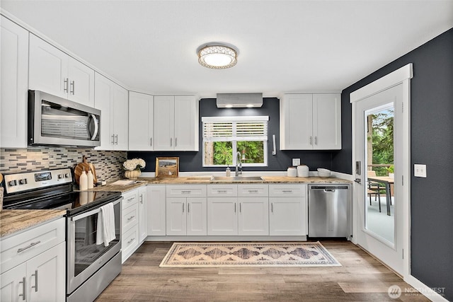 2422 179th Ave E, Lake Tapps, WA 98391 - kitchen featuring stainless steel appliances, plenty of natural light, light wood-type flooring, and white cabinets