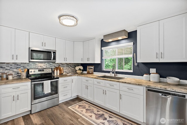 2422 179th Ave E, Lake Tapps, WA 98391 - kitchen with appliances with stainless steel finishes, light countertops, white cabinetry, and backsplash