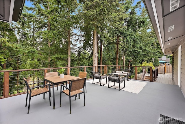 2422 179th Ave E, Lake Tapps, WA 98391 - view of patio with outdoor lounge area, a deck, outdoor dining space, and view of wooded area