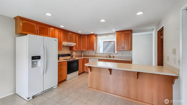 22230 100th Ave SE, Kent, WA 98031 - kitchen featuring white refrigerator with ice dispenser, range with electric cooktop, light countertops, under cabinet range hood, and a kitchen breakfast bar