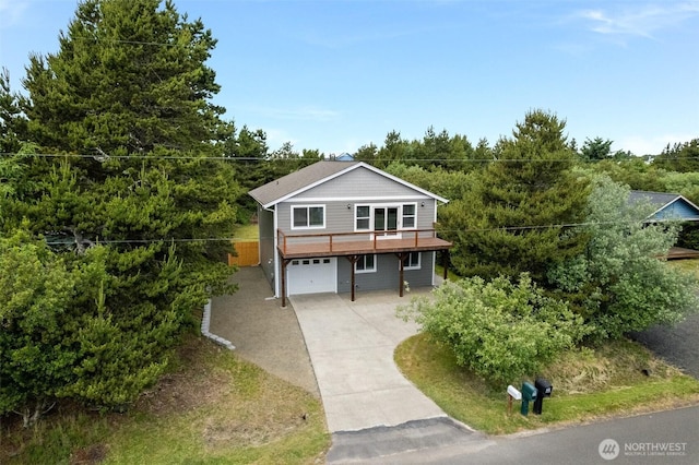 356 N Wynoochee Dr SW, Ocean Shores, WA 98569 - view of front facade with driveway, an attached garage, and a wooden deck