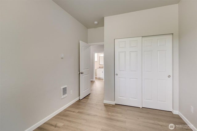 356 N Wynoochee Dr SW, Ocean Shores, WA 98569 - unfurnished bedroom with light wood-type flooring and a closet