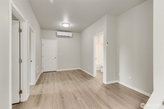 356 N Wynoochee Dr SW, Ocean Shores, WA 98569 - empty room featuring light wood finished floors and an AC wall unit