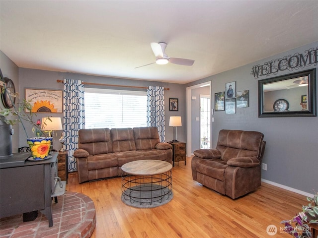 1011 E 5th St, Port Angeles, WA 98362 - living room featuring light wood-type flooring, ceiling fan, and baseboards