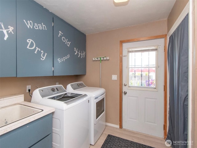 1011 E 5th St, Port Angeles, WA 98362 - washroom with cabinet space, washer and dryer, and light wood-style flooring