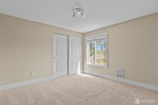 8503 Bowdoin Way Unit 203, Edmonds, WA 98026 - unfurnished bedroom featuring baseboards, carpet, and a closet