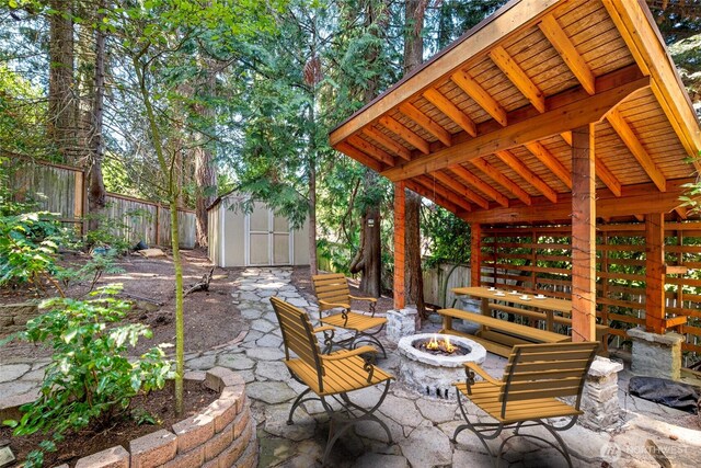 5610 S 296th Ct, Auburn, WA 98001 - fenced backyard featuring a fire pit, a shed, and a patio