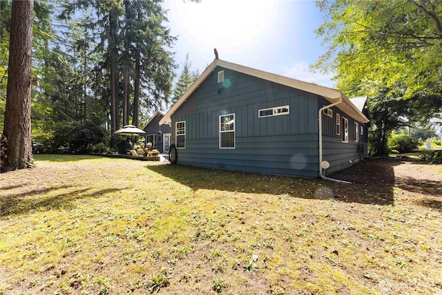 8415 57th Ave E, Puyallup, WA 98371 - view of side of property featuring board and batten siding and a lawn