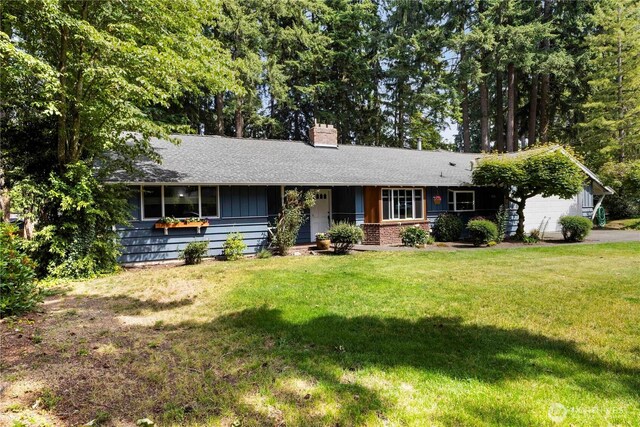 8415 57th Ave E, Puyallup, WA 98371 - ranch-style house featuring a garage, a chimney, a front lawn, a shingled roof, and driveway