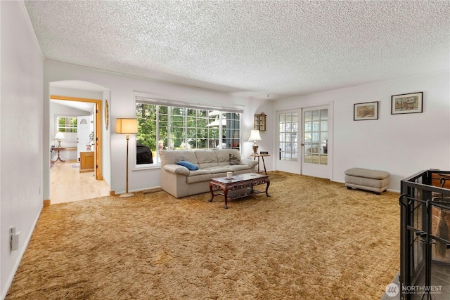 8415 57th Ave E, Puyallup, WA 98371 - carpeted living room with a textured ceiling and arched walkways