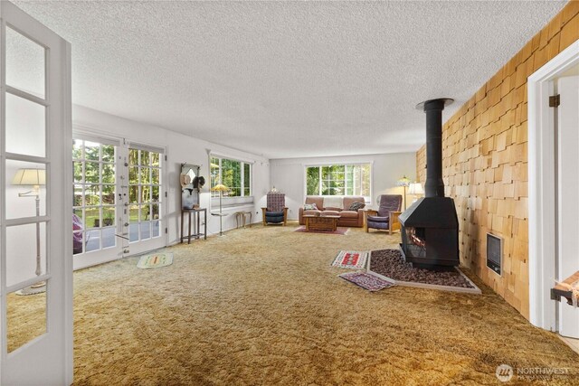 8415 57th Ave E, Puyallup, WA 98371 - carpeted living room with a wood stove, a textured ceiling, and french doors