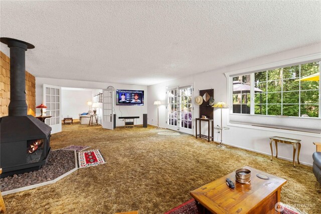 8415 57th Ave E, Puyallup, WA 98371 - living area featuring a wood stove, carpet, and a textured ceiling