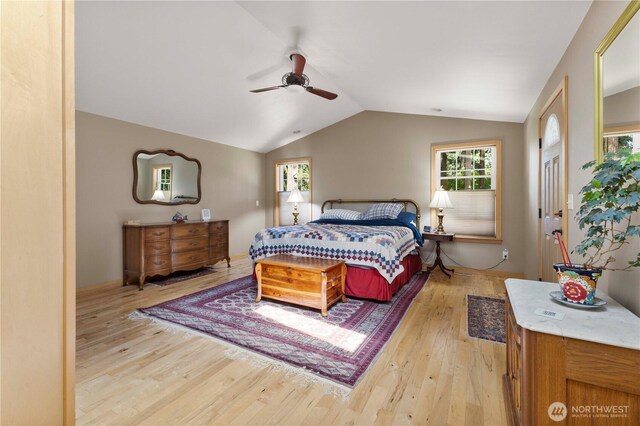 8415 57th Ave E, Puyallup, WA 98371 - bedroom featuring light wood-type flooring, vaulted ceiling, multiple windows, and a ceiling fan